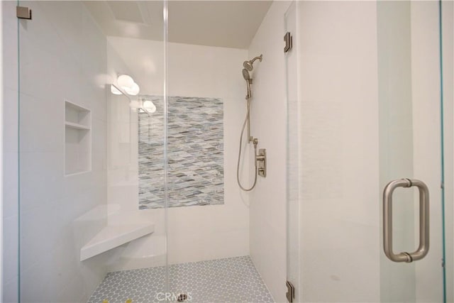 bathroom featuring a shower with shower door