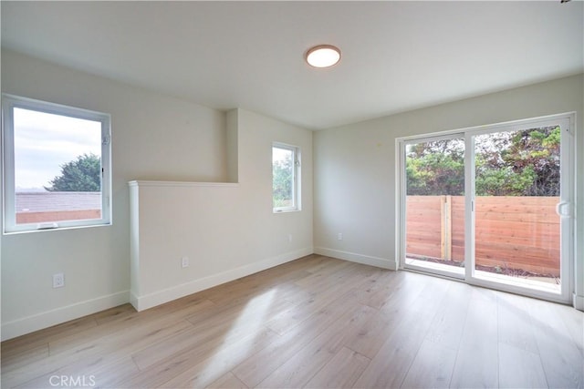 spare room featuring plenty of natural light and light wood-type flooring