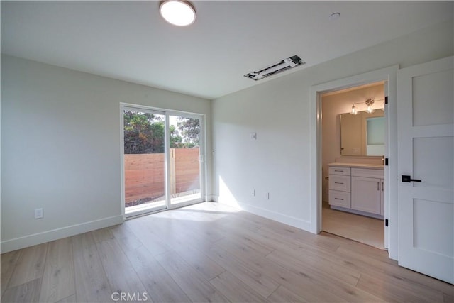 spare room with light hardwood / wood-style floors