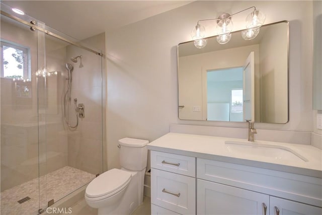 bathroom featuring vanity, toilet, and an enclosed shower