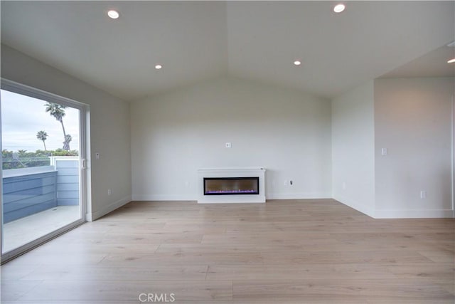 unfurnished living room with light hardwood / wood-style flooring and vaulted ceiling