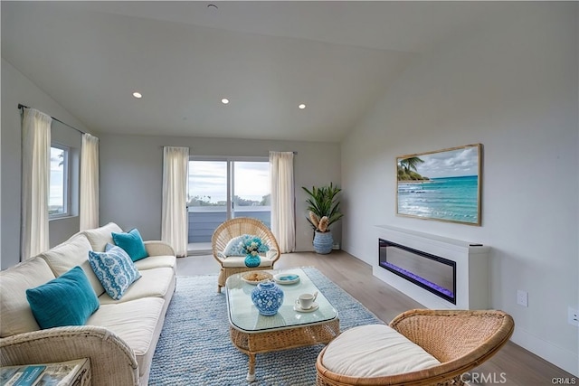 living room featuring light hardwood / wood-style floors and vaulted ceiling