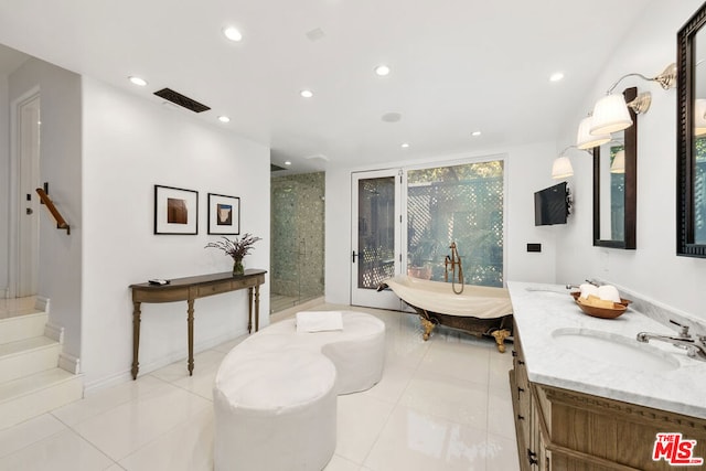 bathroom featuring vanity, tile patterned floors, and separate shower and tub