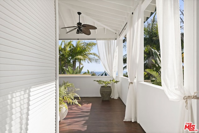 exterior space featuring vaulted ceiling with beams and ceiling fan