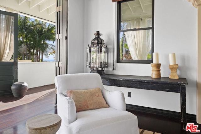 sitting room with beamed ceiling and hardwood / wood-style flooring