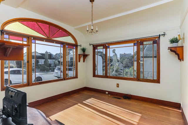 interior space featuring an inviting chandelier and hardwood / wood-style flooring