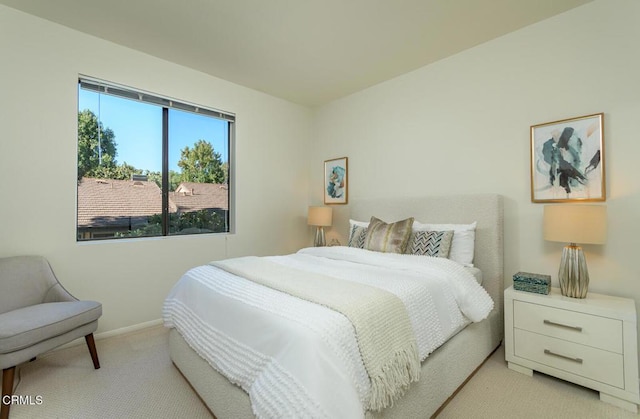 bedroom featuring light colored carpet