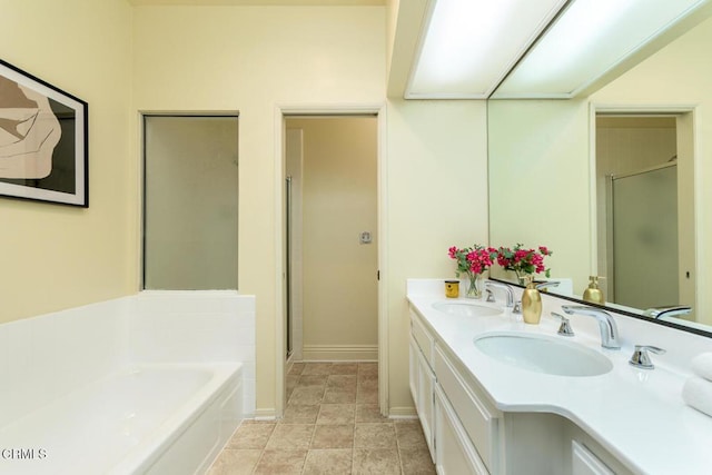 bathroom with vanity and independent shower and bath