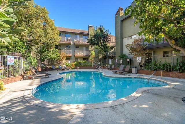 view of swimming pool with a patio