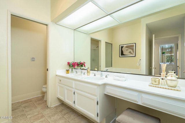 bathroom featuring tile patterned flooring, vanity, and toilet