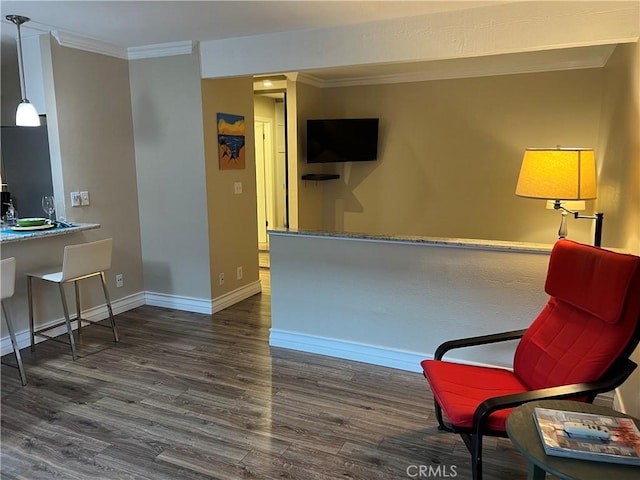 living area with crown molding and dark wood-type flooring