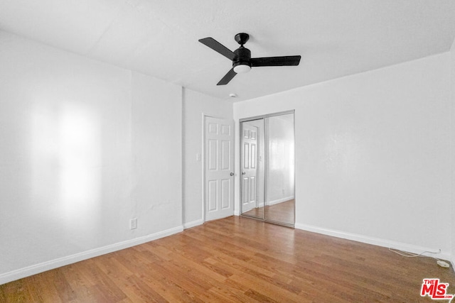 unfurnished room with ceiling fan and hardwood / wood-style flooring