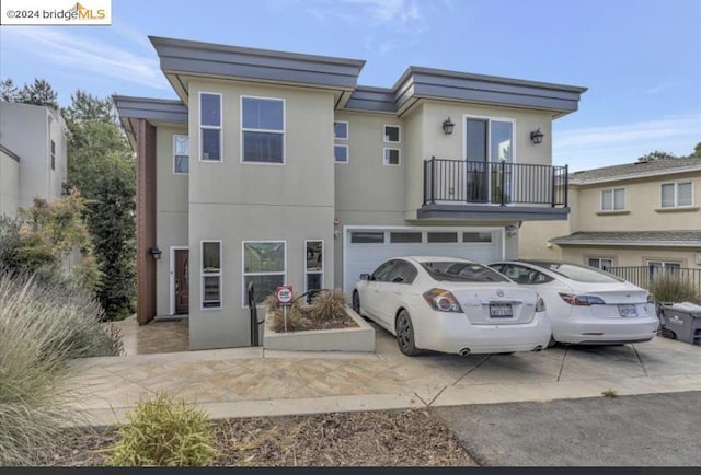 view of front facade with a balcony and a garage