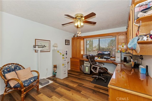 office area with dark hardwood / wood-style floors, ceiling fan, and a textured ceiling