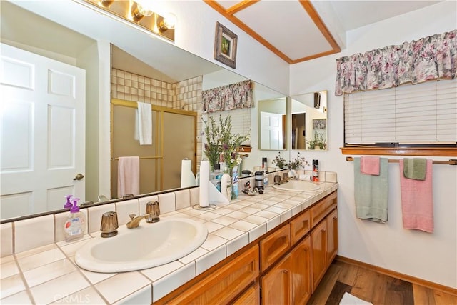 bathroom featuring vanity, a shower with shower door, and hardwood / wood-style flooring