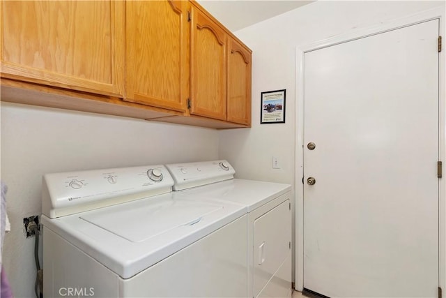 laundry room featuring cabinets and separate washer and dryer