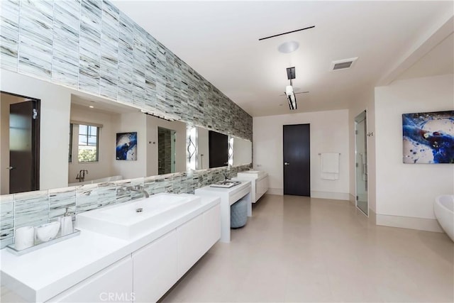 bathroom featuring tasteful backsplash, independent shower and bath, vanity, and concrete floors