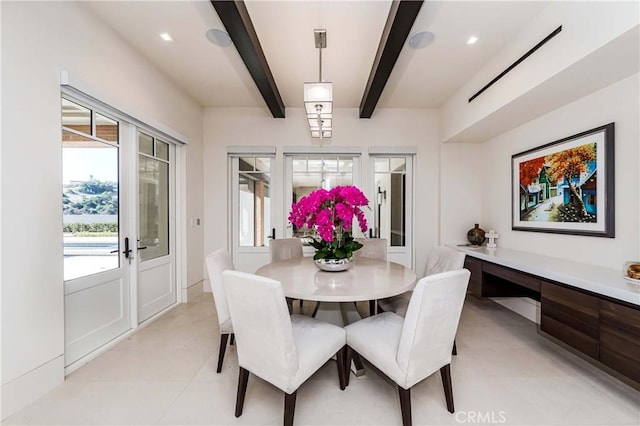 dining space featuring beam ceiling