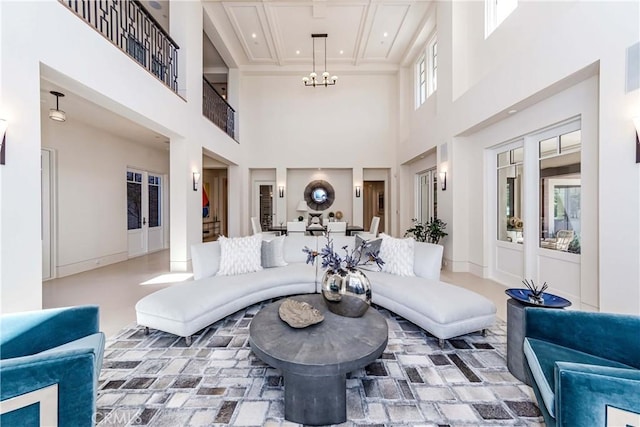 living room with a towering ceiling and a notable chandelier