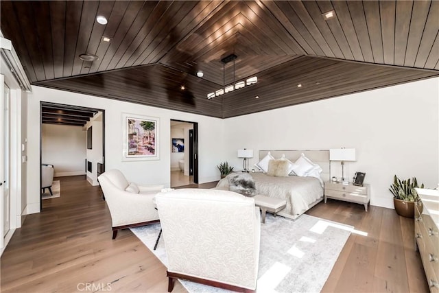 bedroom featuring hardwood / wood-style floors, wooden ceiling, and vaulted ceiling