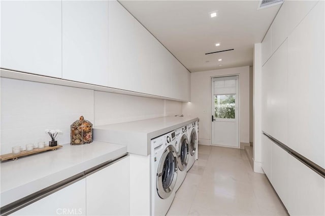 clothes washing area with washing machine and dryer