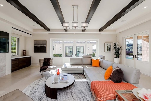 living room with beam ceiling, plenty of natural light, and french doors