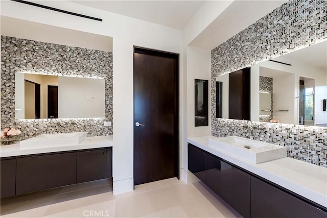 bathroom with vanity and tasteful backsplash