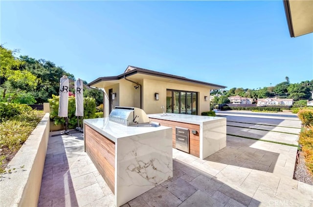 view of patio / terrace featuring a grill and exterior kitchen