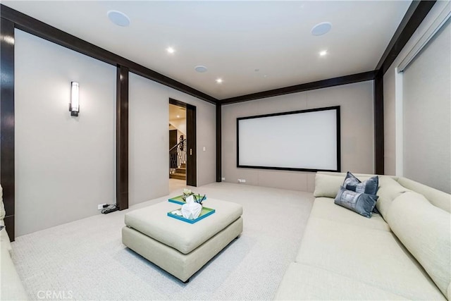 carpeted cinema room with ornamental molding