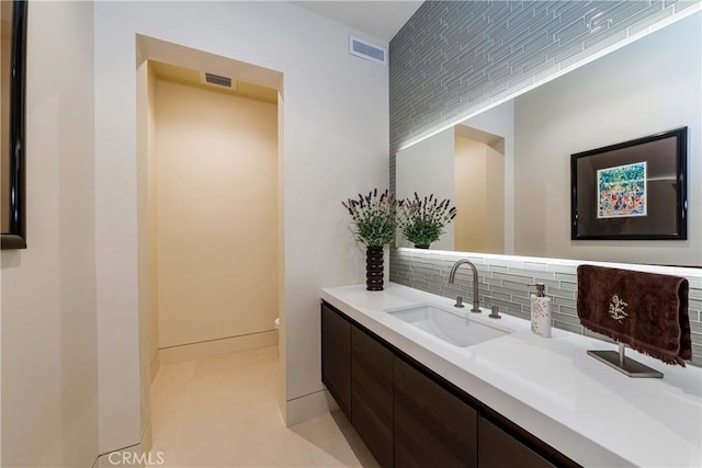 bathroom with tasteful backsplash and vanity