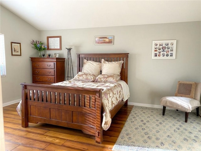 bedroom featuring hardwood / wood-style floors and lofted ceiling