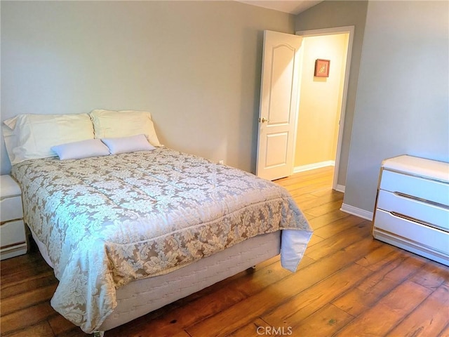 bedroom with hardwood / wood-style floors