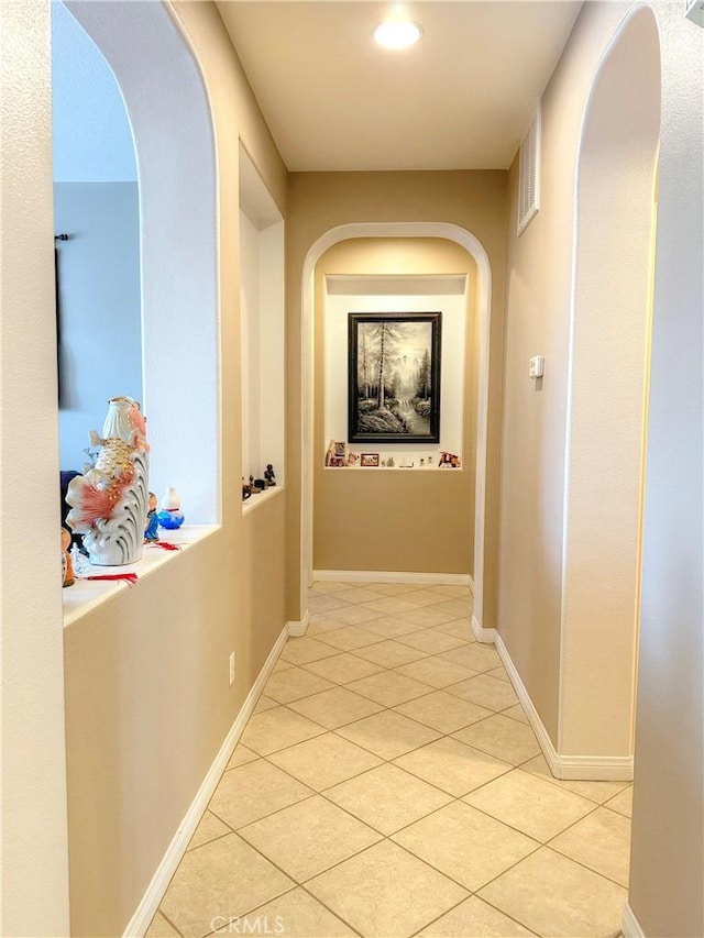 hallway featuring light tile patterned flooring