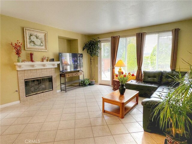 tiled living room featuring a tile fireplace