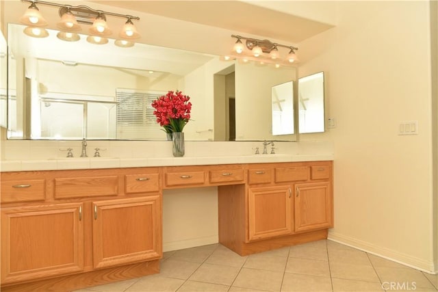 bathroom featuring tile patterned floors, vanity, and an enclosed shower