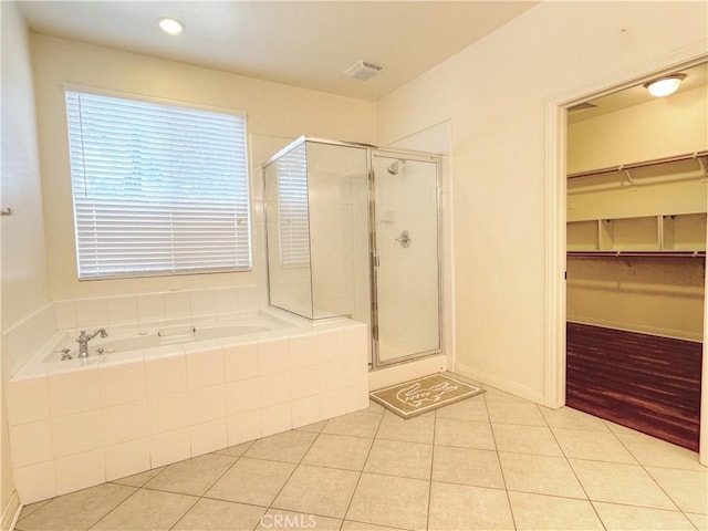 bathroom featuring tile patterned flooring and independent shower and bath