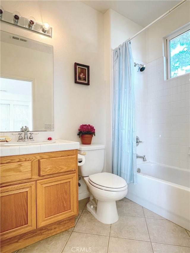 full bathroom featuring tile patterned flooring, vanity, shower / tub combo with curtain, and toilet