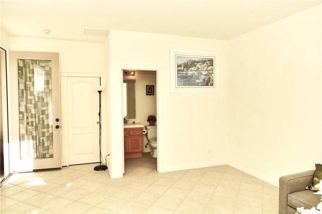 tiled empty room with sink