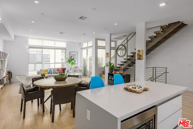 dining area featuring light wood-type flooring and beverage cooler