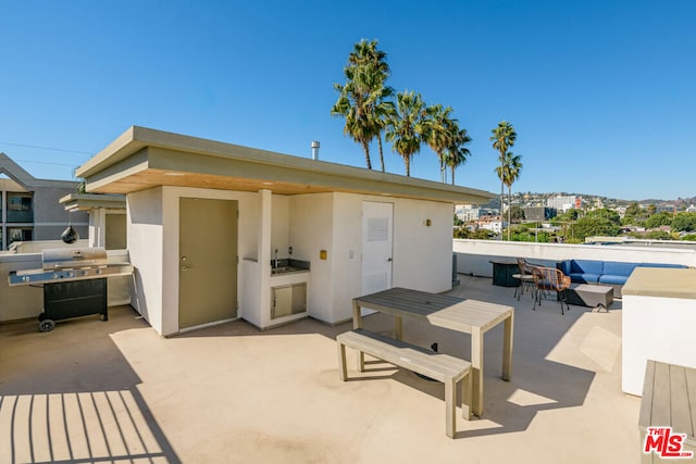 view of patio with area for grilling, a grill, and outdoor lounge area