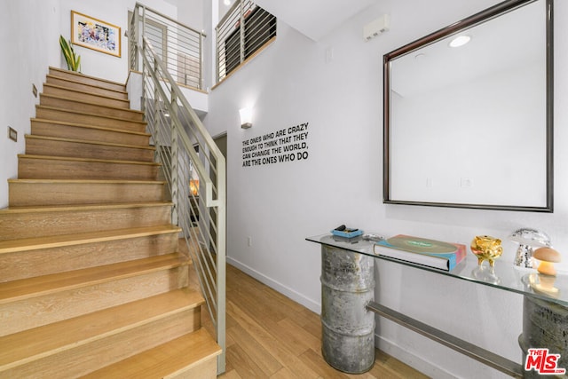 stairway featuring hardwood / wood-style floors