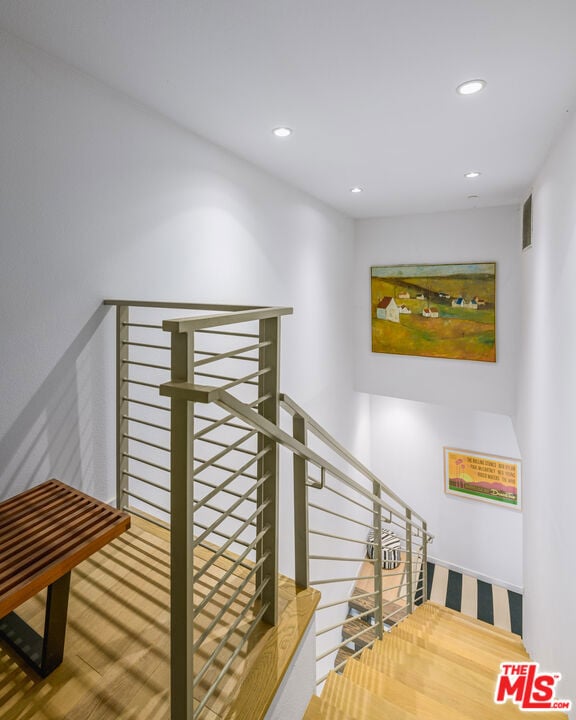 staircase featuring wood-type flooring