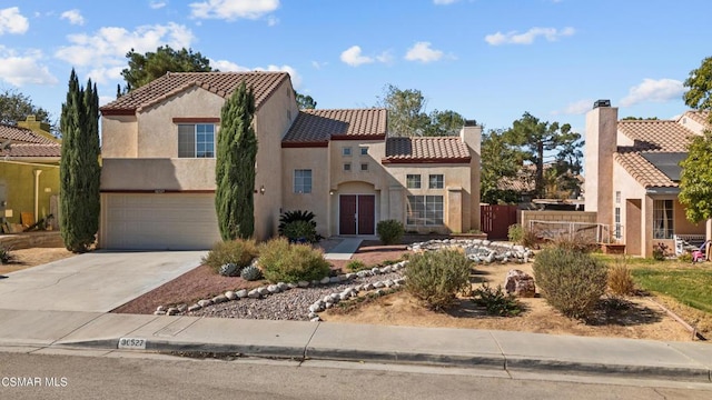 mediterranean / spanish-style house with a garage