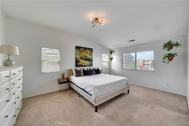 bedroom with light colored carpet and vaulted ceiling