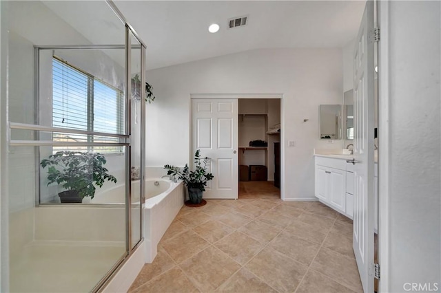 bathroom featuring tile patterned floors, vanity, lofted ceiling, and shower with separate bathtub