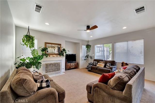 living room featuring light colored carpet and ceiling fan