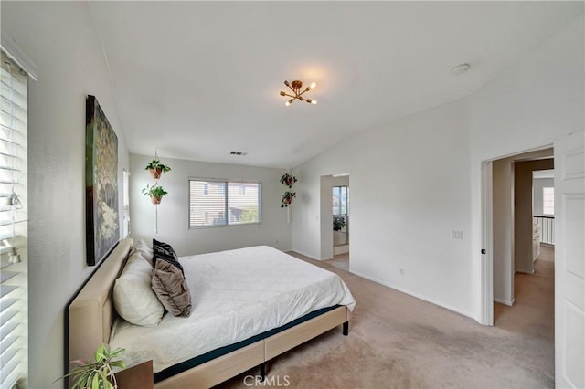 carpeted bedroom with vaulted ceiling