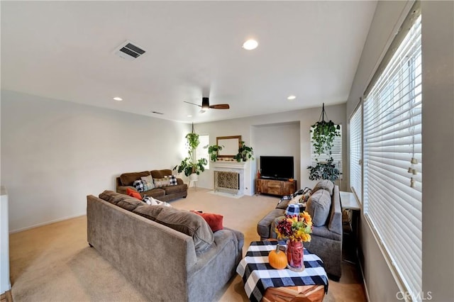 carpeted living room with ceiling fan