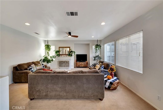 living room with light colored carpet and ceiling fan