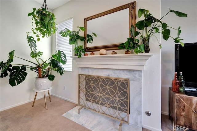 living area with light carpet and a fireplace